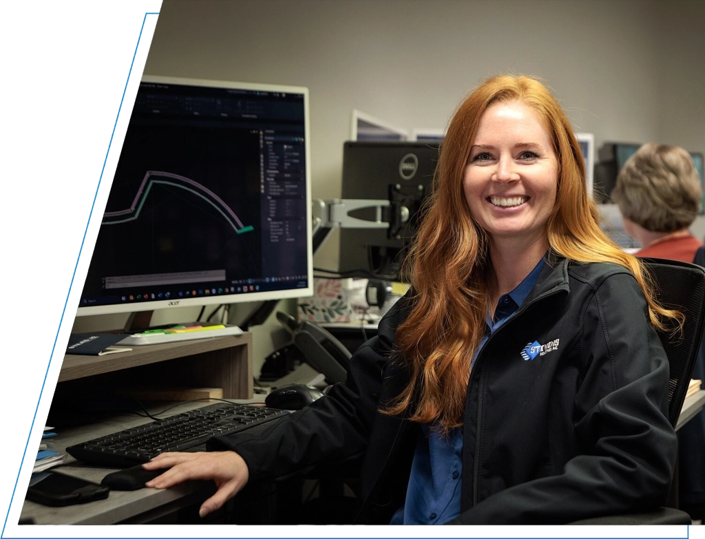 Women employee smiling at her desk